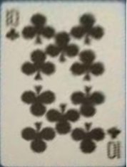 A playing card photographed at an angle, used as a controlled test target for the perspective-correction algorithm