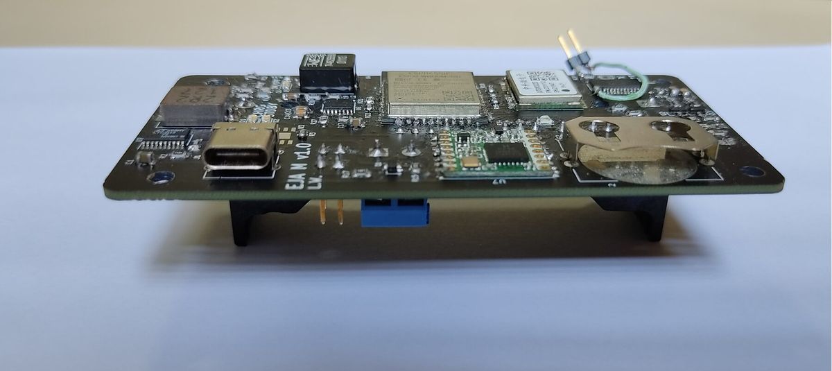 Side view of the assembled EJA M v1.0 board, with the USB-C connector and modules on top and parts mounted on the back layer