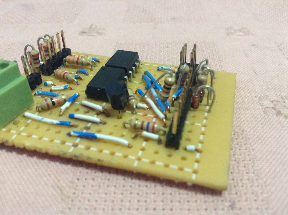 The hand-wired perfboard with two DIP ICs and many resistors that conditions the sensor and encoder signals