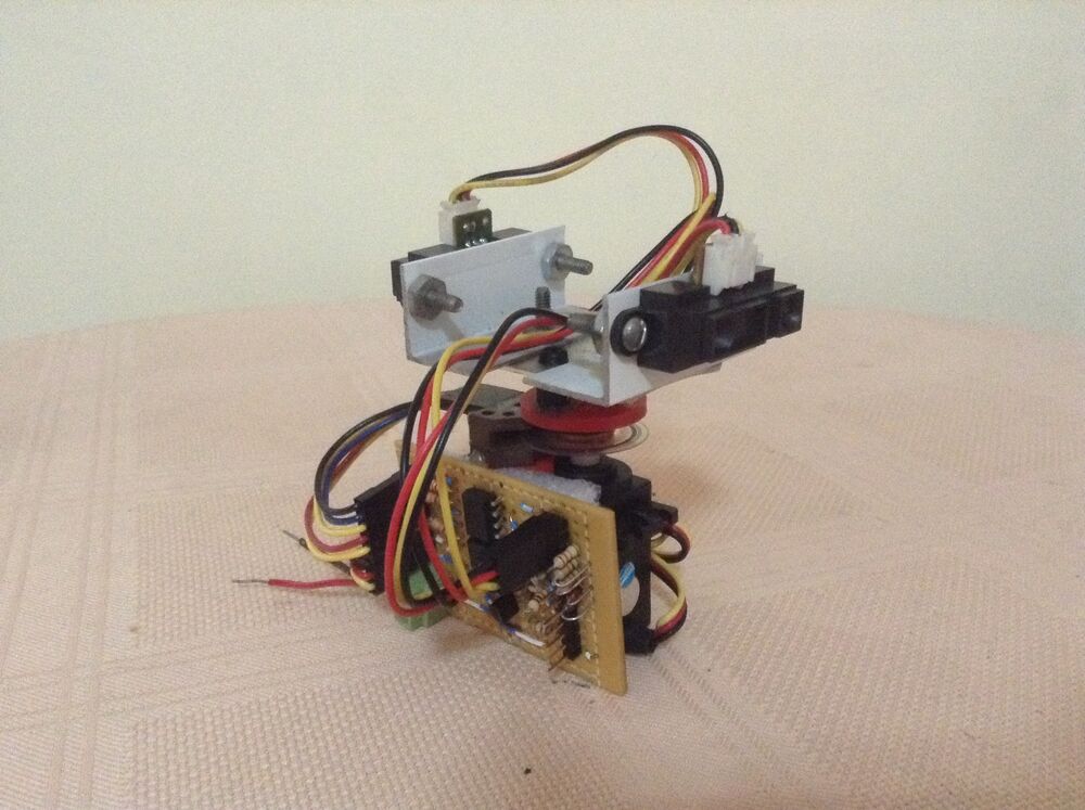 The assembled IRDAR turret: a servo at the base, a hand-wired signal board on its front, and an aluminium bracket on top holding an infrared sensor, mounted on a slip-ring bearing