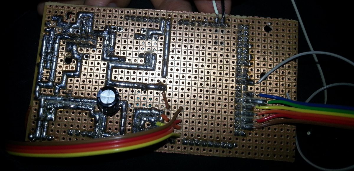 The underside of the Arduino Mega shield perfboard, showing the hand-soldered tin traces connecting all the sensor headers